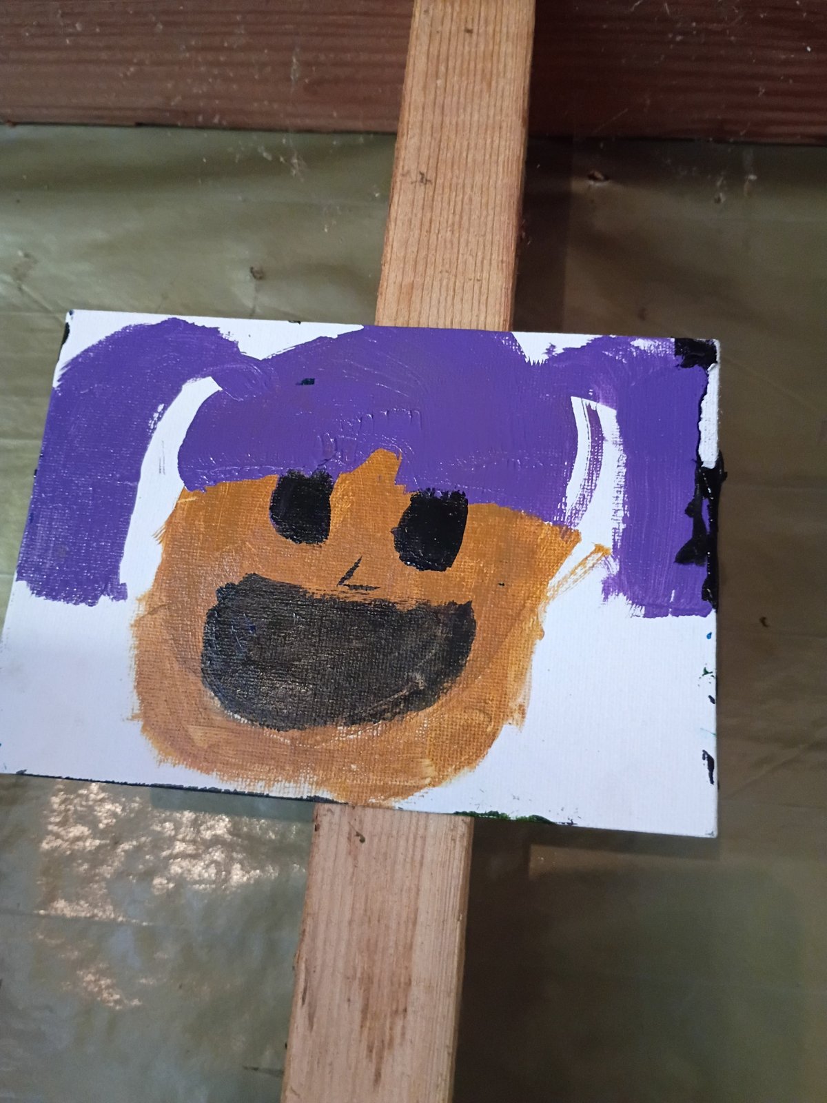 A smiling painted face with purple hair