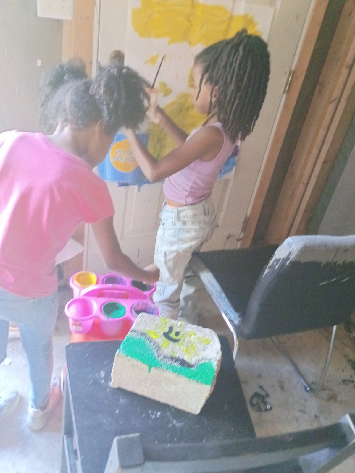 Young artists working together inside the garage