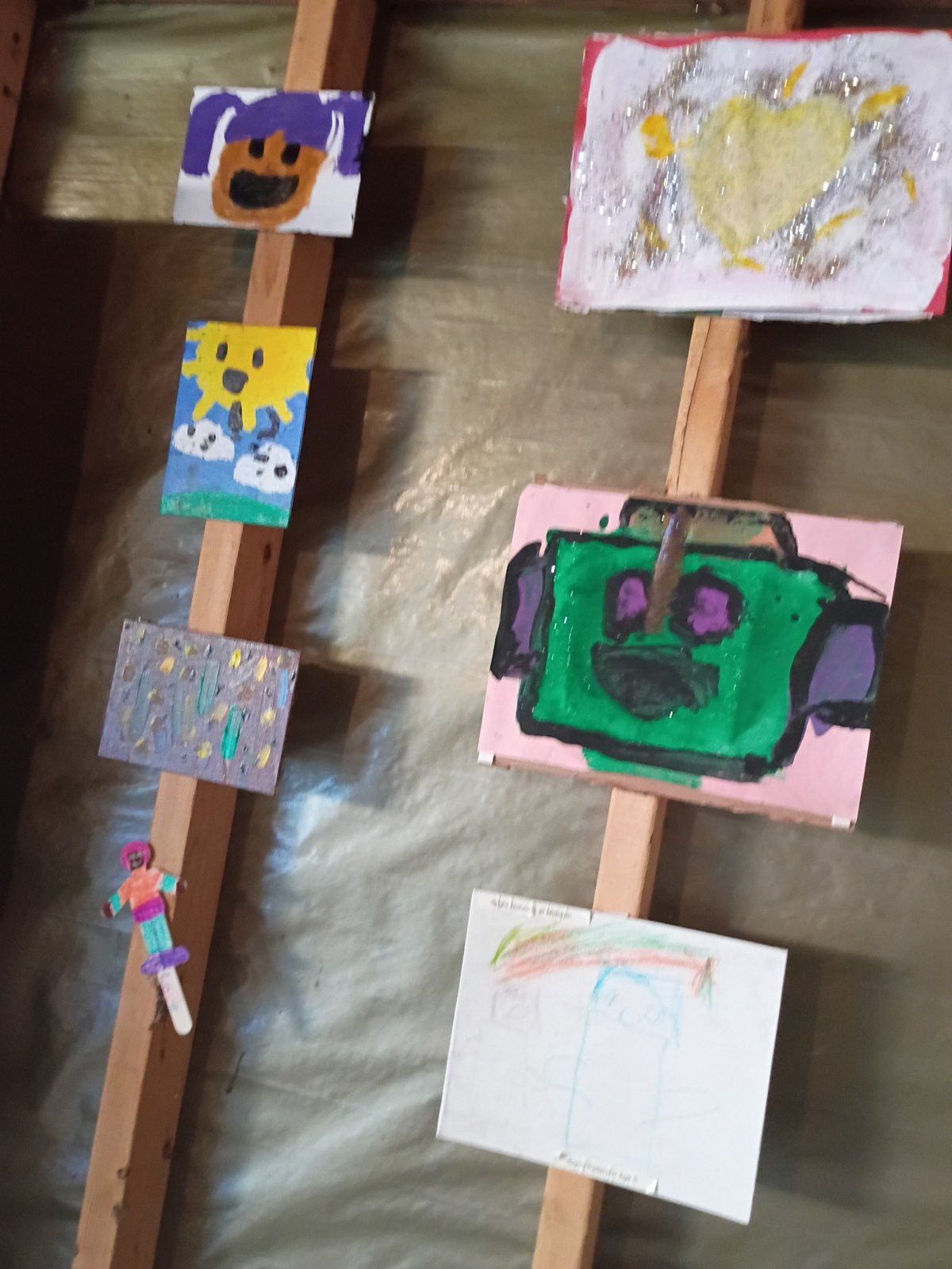 Student paintings displayed in the garage